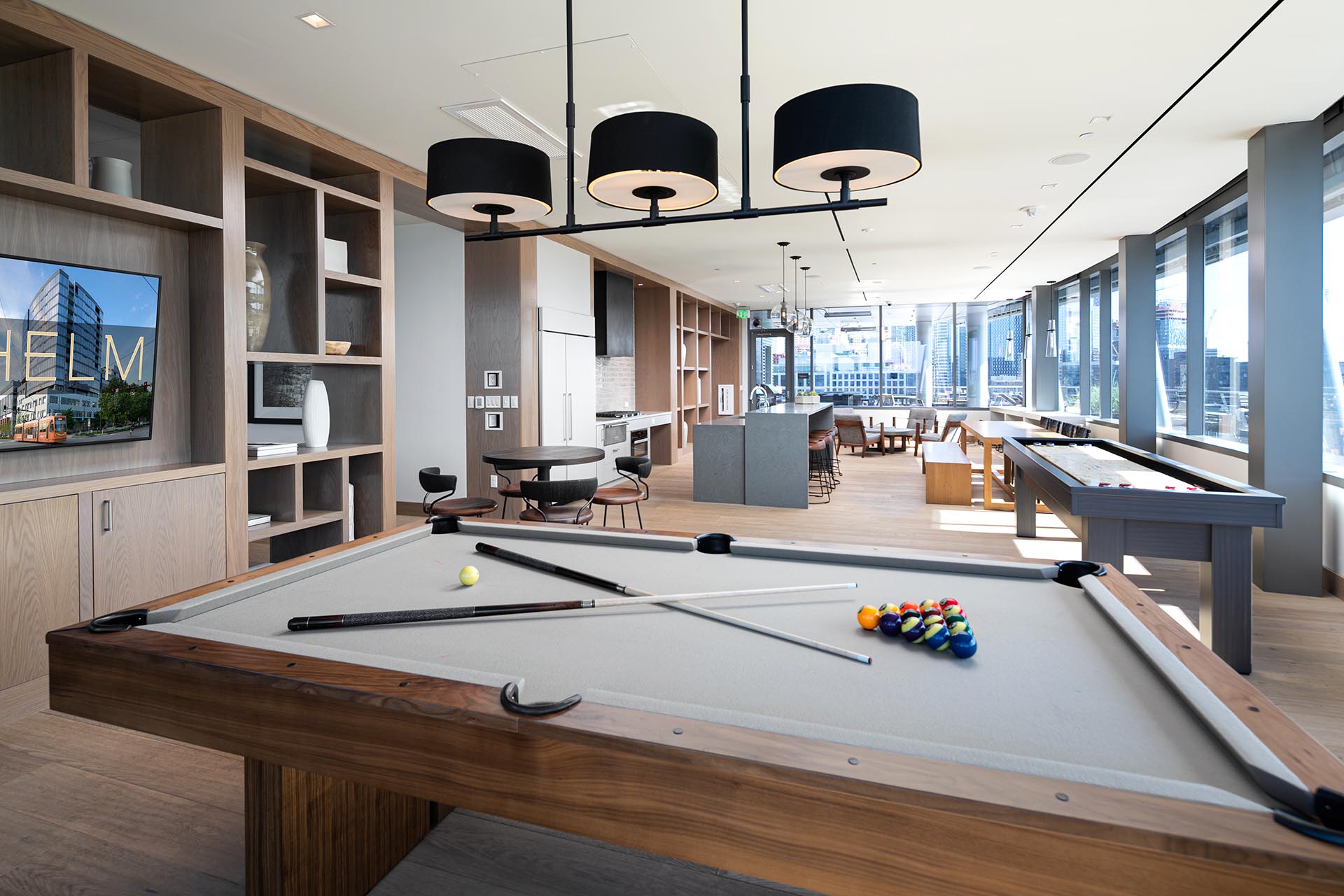 Large game room with a pool table and various table top games, a spacious counter top area and seating throughout