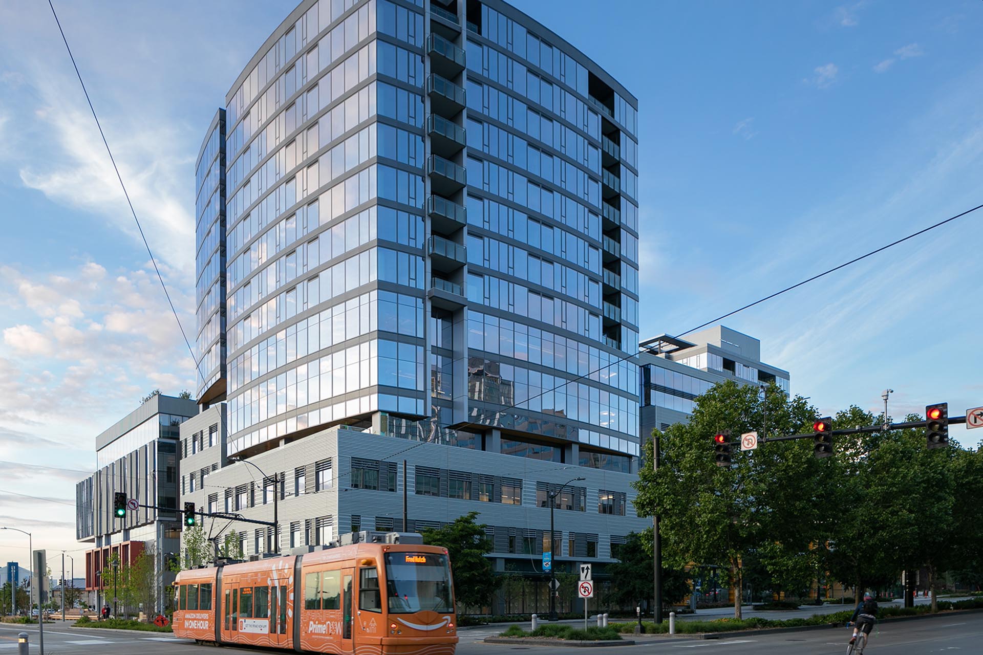 Exterior view of Helm SLU with the South Lake Union Transit passing by