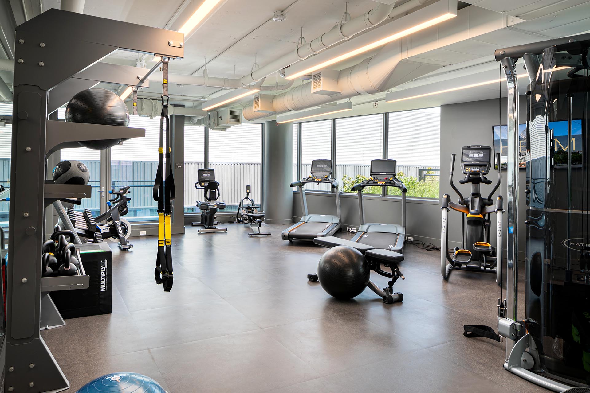 Open, light gym area with excercise equipment