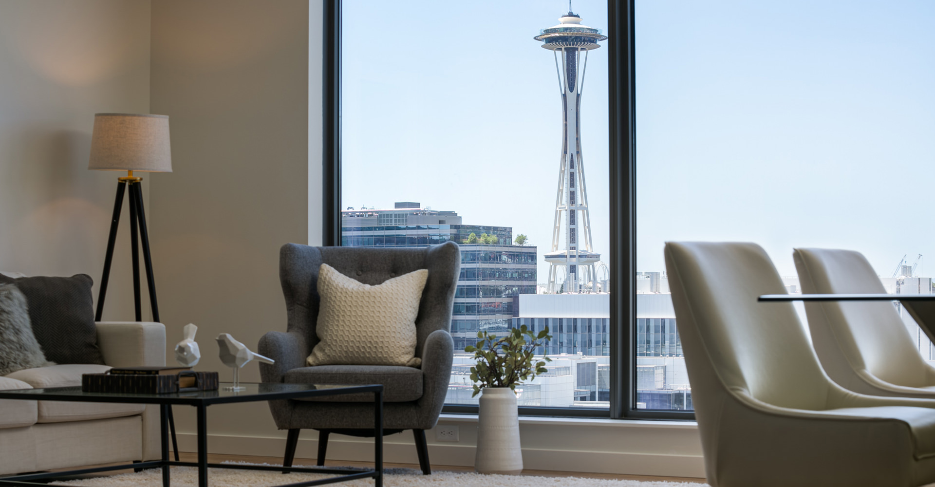 Attractive furnished living room with a view of the Space Needle
